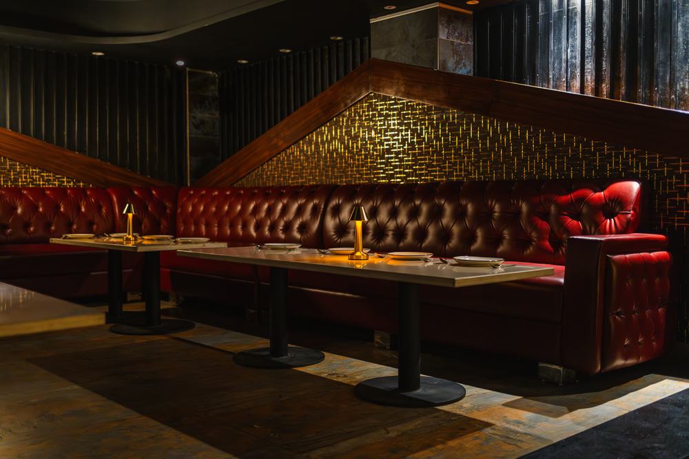 Bellers, the room from the entrance — booths, the bottle wall and the screen beyond