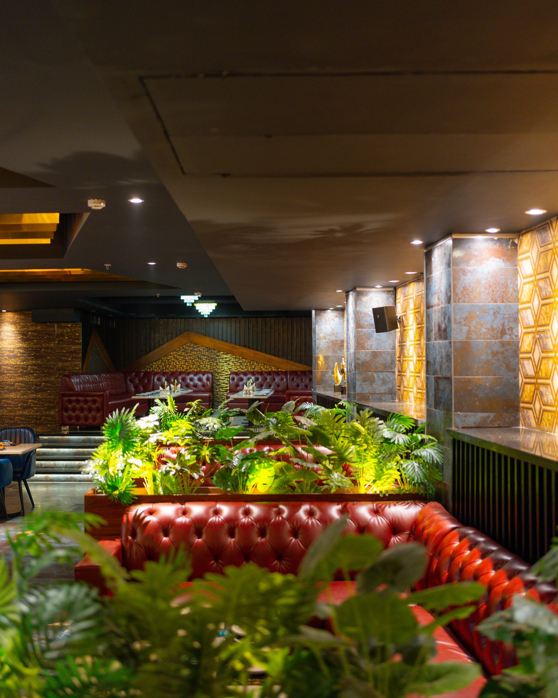 Bellers, the red banquettes seen past the planters