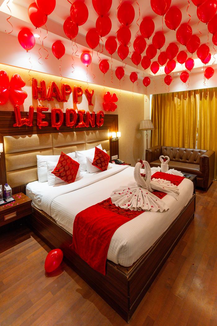 A room under a ceiling of red balloons
