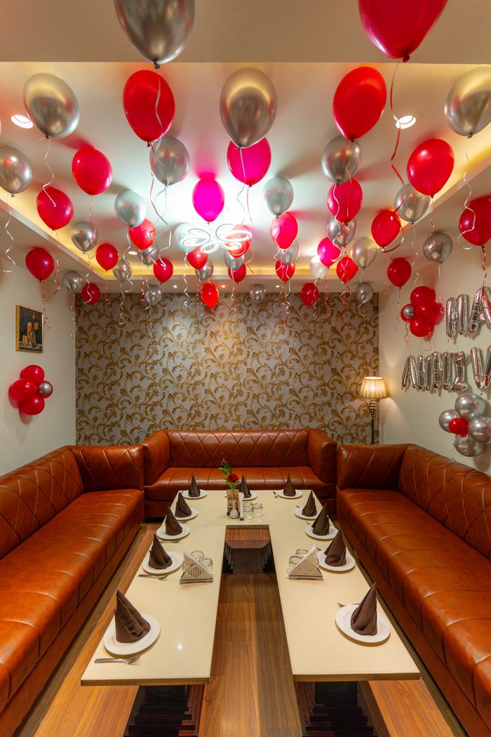 A private dining room under balloons, tables laid