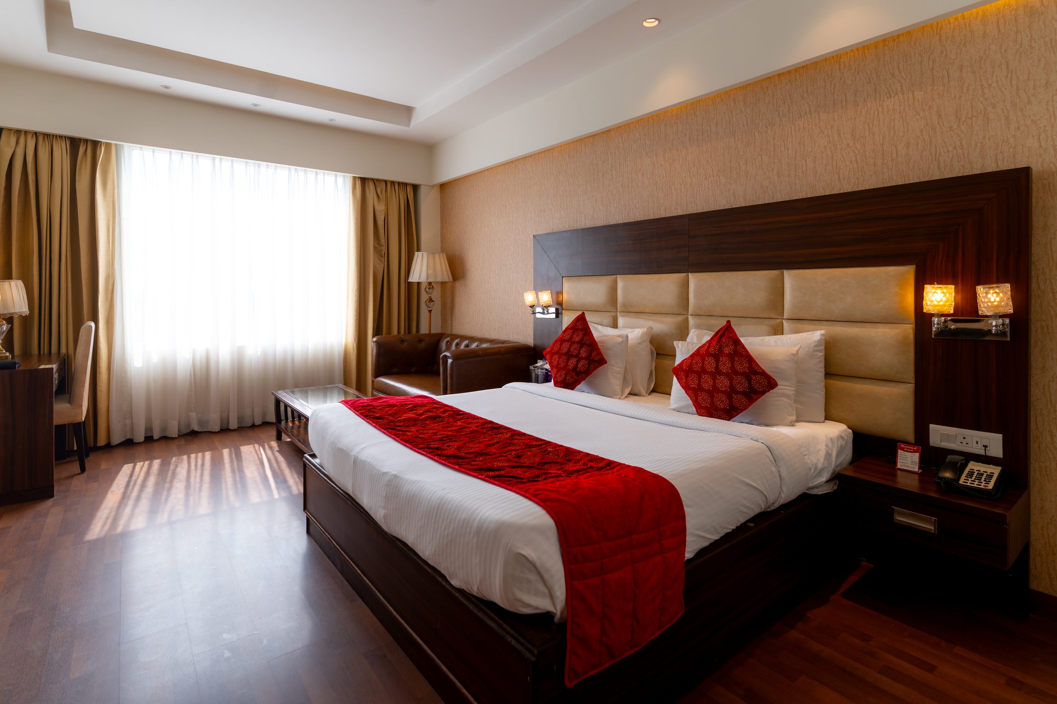 An Executive Room with the curtains drawn back, daylight across the bed