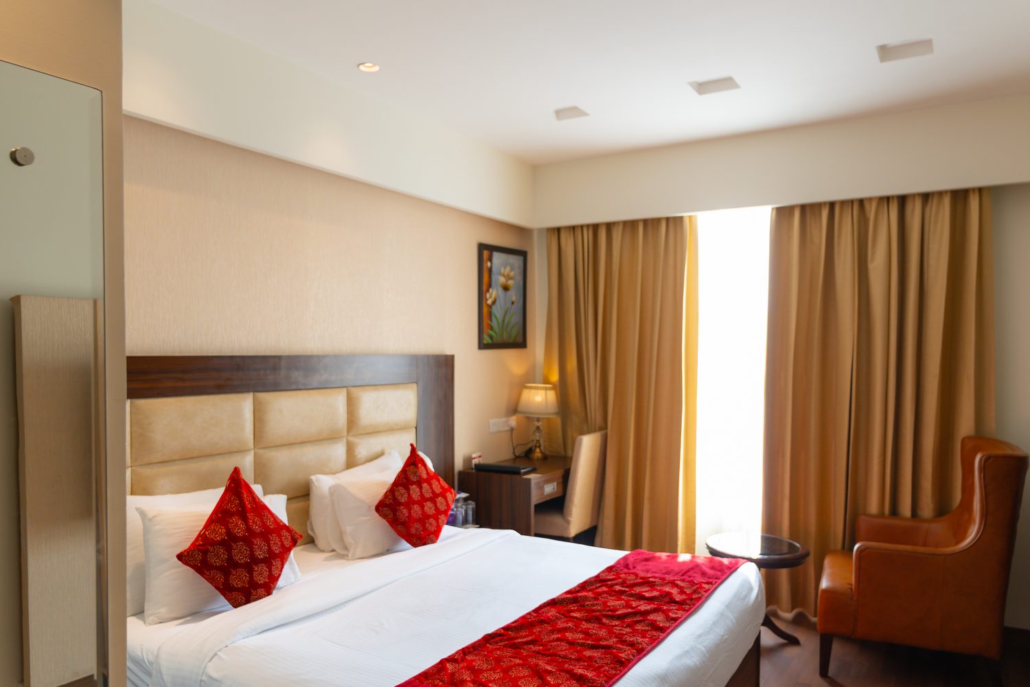 An Executive Room, king bed and armchair on walnut flooring