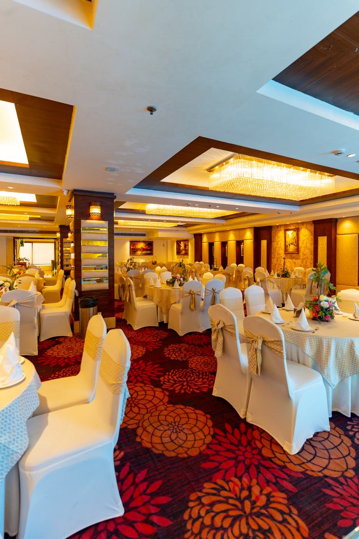 The hall in white against the crimson carpet