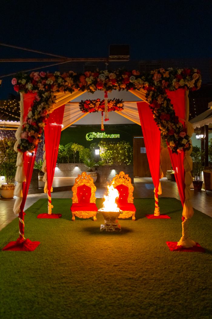 The lawn set with a floral mandap after dark