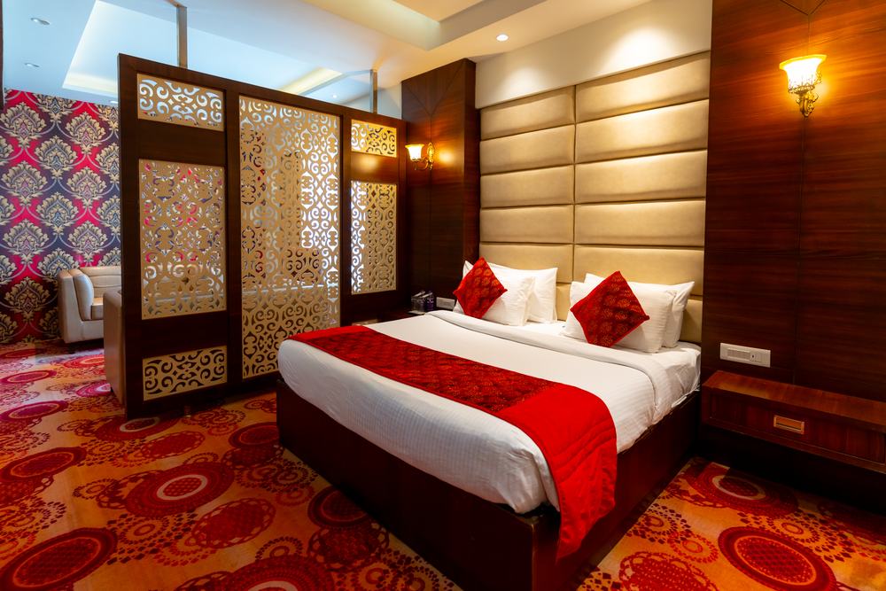A Suite, the bed framed by the carved screen